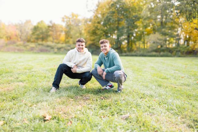 two young men squatting together